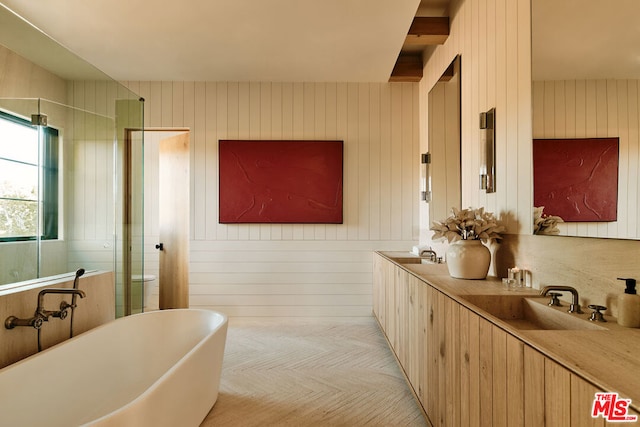 bathroom with independent shower and bath, wood walls, and vanity