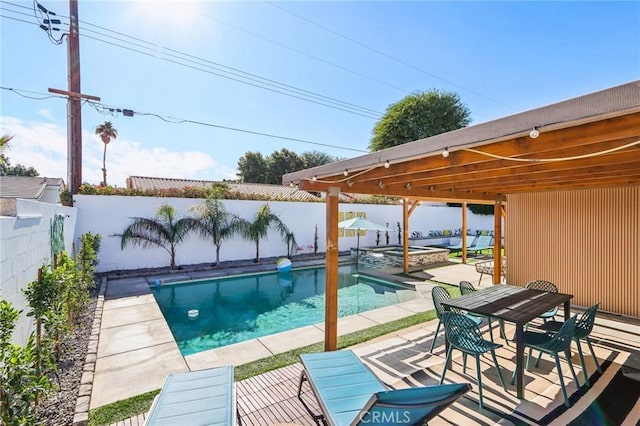 view of pool with a patio area and an in ground hot tub