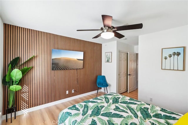 bedroom with ceiling fan and wood-type flooring