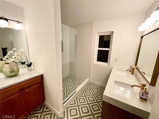 bathroom with vanity and tiled shower