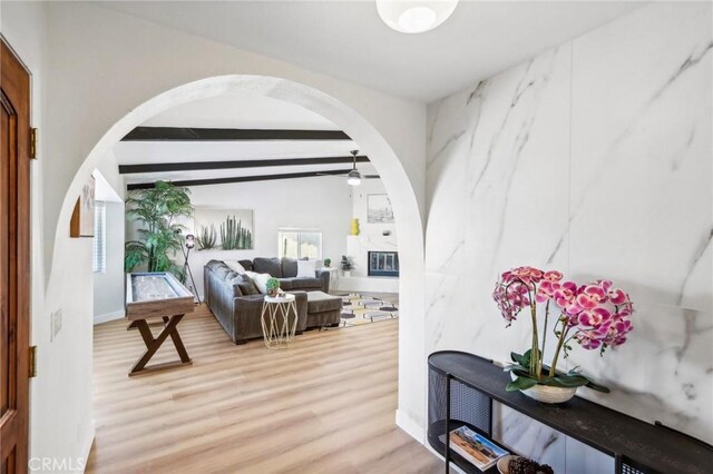 interior space with hardwood / wood-style floors, a high end fireplace, and beam ceiling