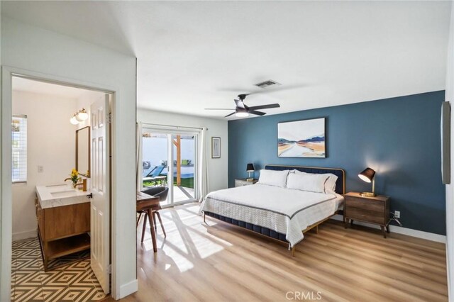 bedroom featuring access to exterior, light wood finished floors, baseboards, and visible vents