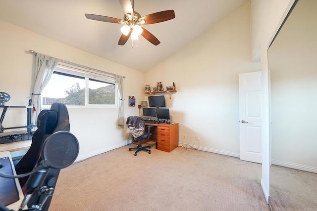 carpeted home office featuring vaulted ceiling and ceiling fan