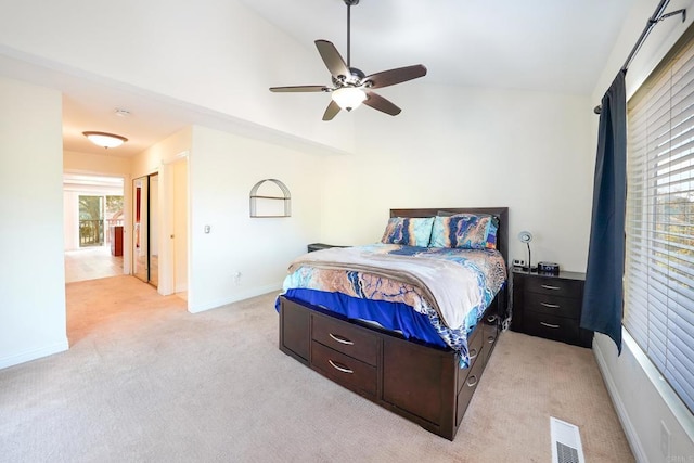 carpeted bedroom with vaulted ceiling and ceiling fan