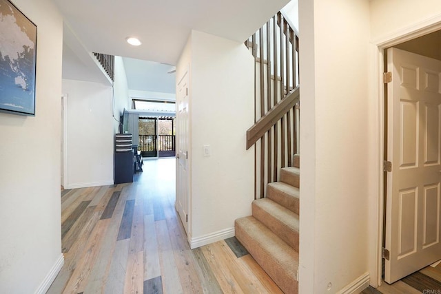 stairs featuring hardwood / wood-style flooring