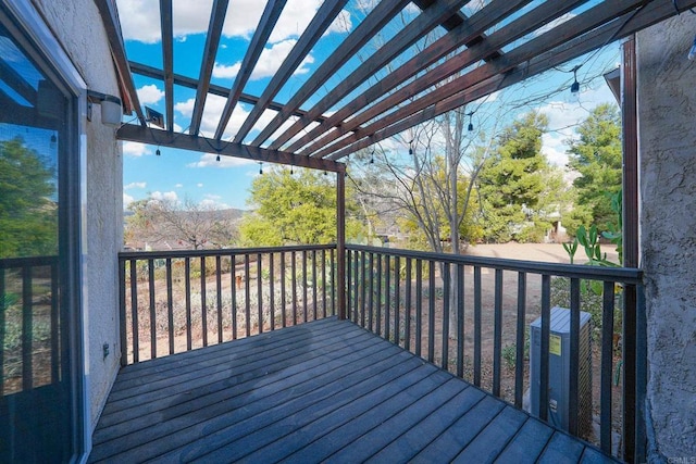 wooden terrace featuring central air condition unit and a pergola