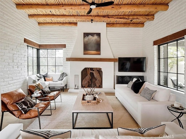 living room featuring ceiling fan, brick wall, wooden ceiling, and beamed ceiling