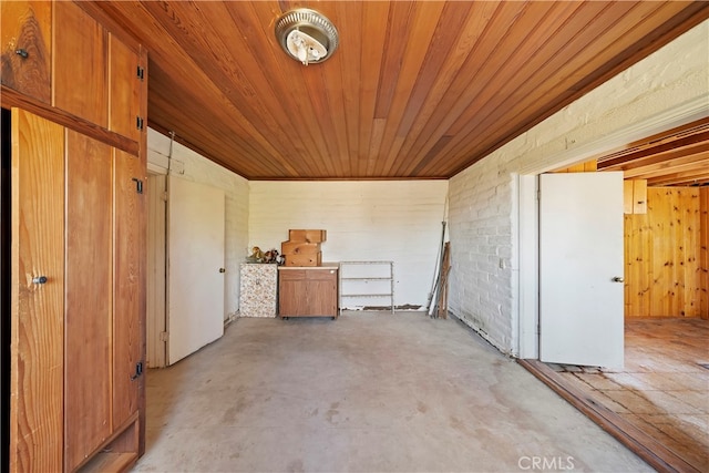 interior space featuring brick wall and wooden ceiling