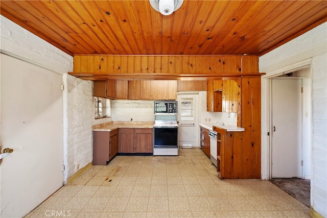 kitchen featuring white range with electric stovetop, a wealth of natural light, built in microwave, and dishwashing machine