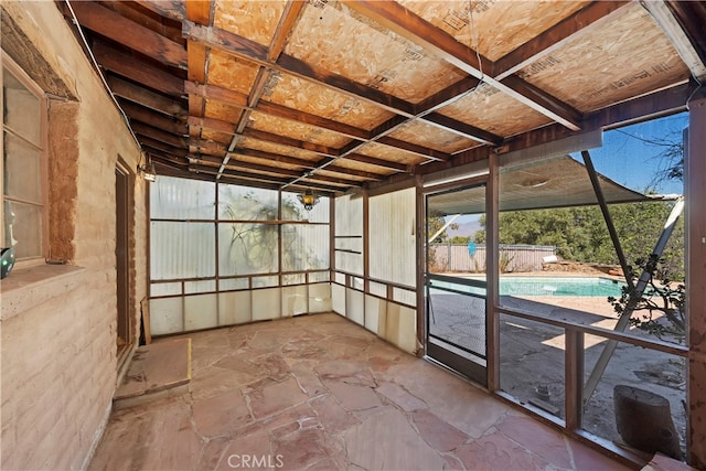 unfurnished sunroom with beam ceiling and coffered ceiling