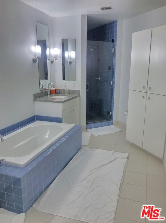 bathroom with separate shower and tub, tile patterned flooring, and vanity