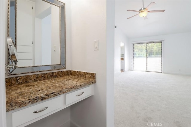 bathroom featuring ceiling fan, vanity, and vaulted ceiling