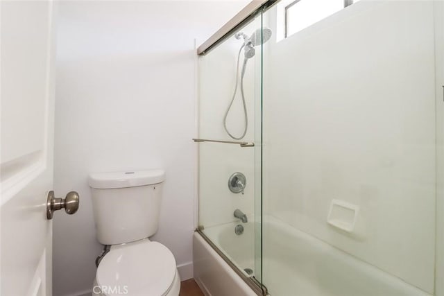 bathroom with enclosed tub / shower combo and toilet