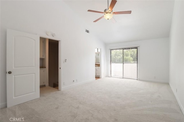 empty room featuring ceiling fan, light colored carpet, and high vaulted ceiling