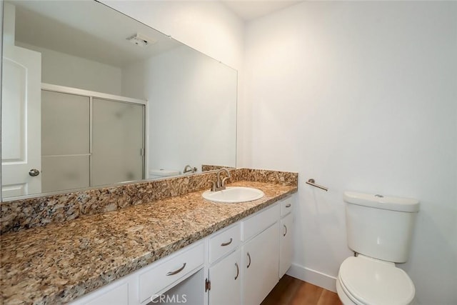 bathroom featuring hardwood / wood-style floors, toilet, and vanity