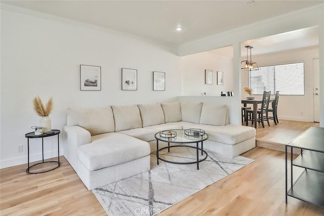 living room featuring ornamental molding and light hardwood / wood-style floors