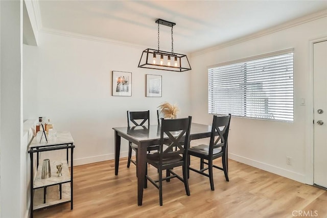 dining area with crown molding and light wood-type flooring