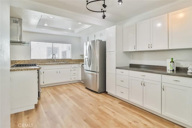 kitchen with white cabinets and stainless steel fridge