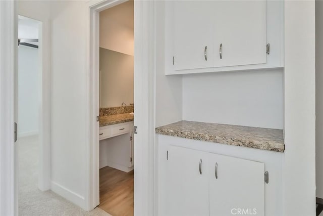 kitchen with white cabinets and light stone countertops