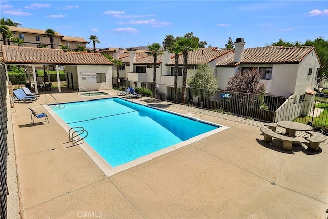 view of pool featuring a community hot tub and a patio