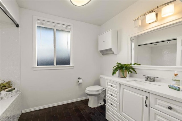 bathroom with vanity, hardwood / wood-style flooring, and toilet