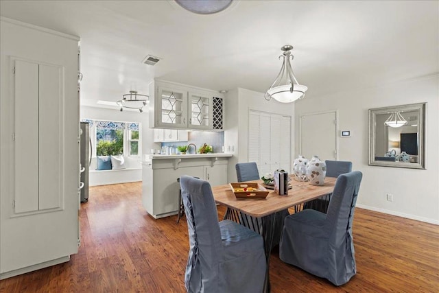 dining room featuring dark wood-type flooring and sink