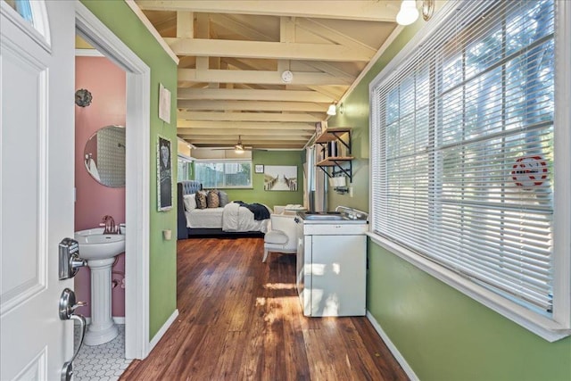 interior space featuring sink, lofted ceiling with beams, dark hardwood / wood-style floors, and a healthy amount of sunlight