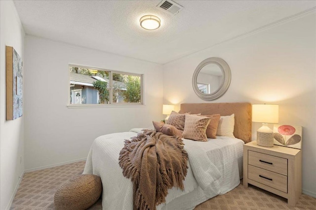 carpeted bedroom featuring a textured ceiling