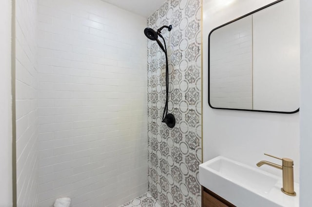 bathroom with vanity and a tile shower