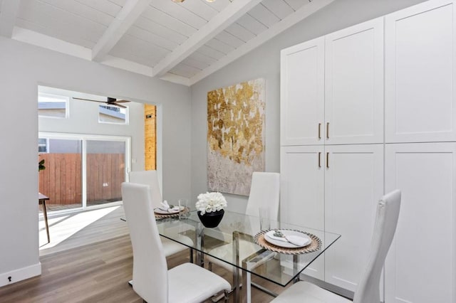 dining room with wooden ceiling, light hardwood / wood-style floors, and vaulted ceiling with beams