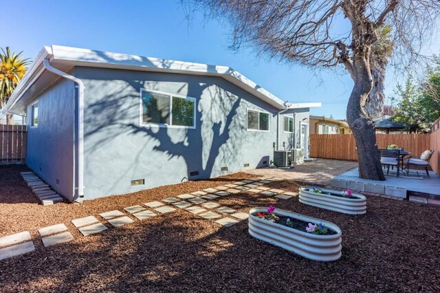 rear view of property featuring central AC and a patio