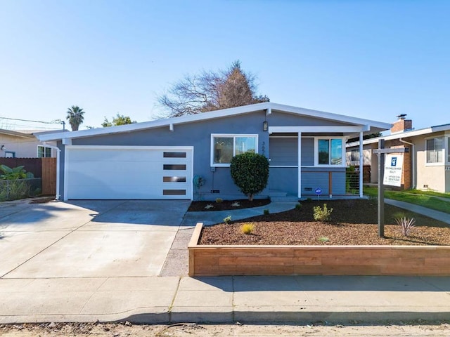 ranch-style home featuring a garage and covered porch