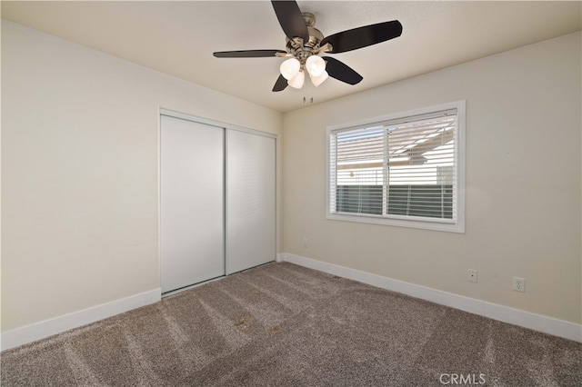 unfurnished bedroom featuring a closet, carpet floors, and ceiling fan