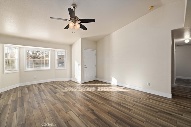 unfurnished living room featuring lofted ceiling, ceiling fan, and dark hardwood / wood-style flooring