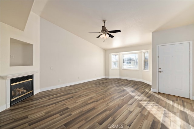 unfurnished living room with dark wood-type flooring and ceiling fan