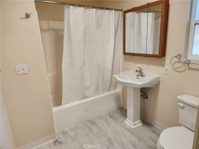 bathroom featuring toilet and shower / bath combination with curtain