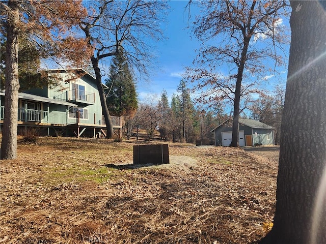 view of yard with a garage and an outbuilding