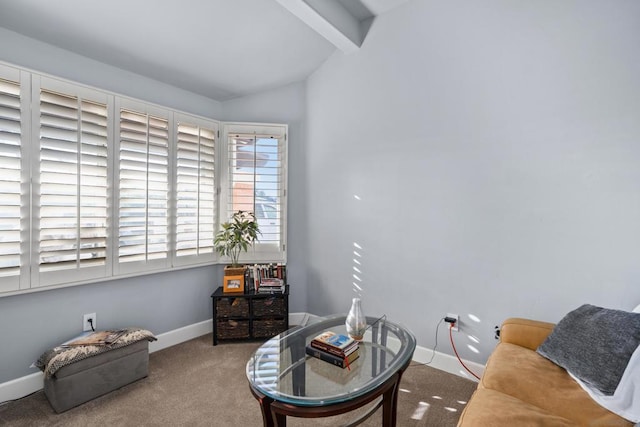 living area with carpet and vaulted ceiling with beams