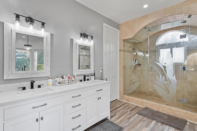 bathroom with vanity, hardwood / wood-style flooring, and walk in shower