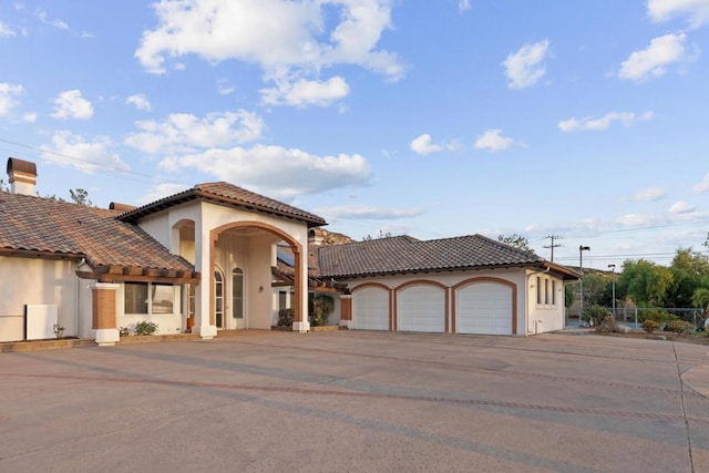 mediterranean / spanish home featuring a garage