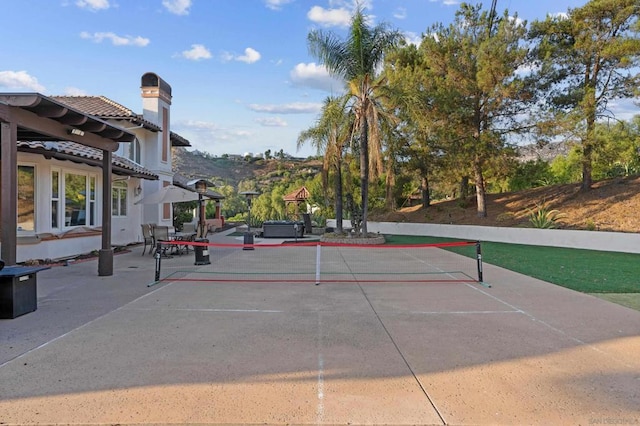 view of tennis court with a mountain view