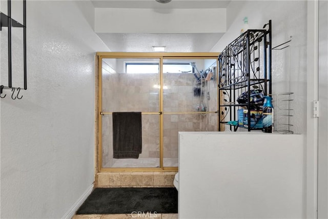 bathroom featuring toilet and walk in shower