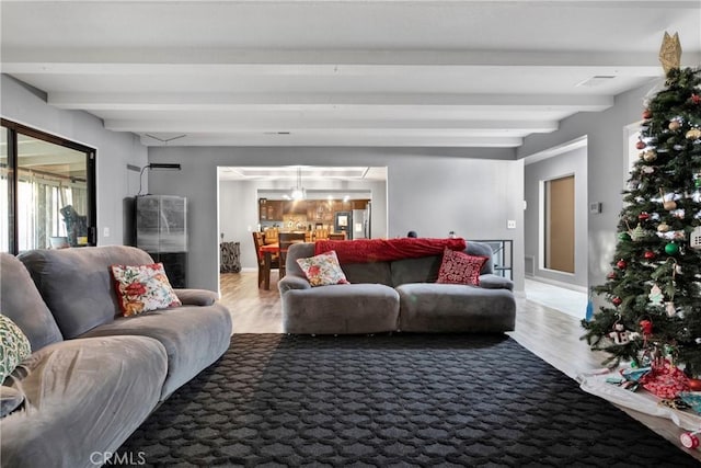 living room featuring hardwood / wood-style floors and beamed ceiling