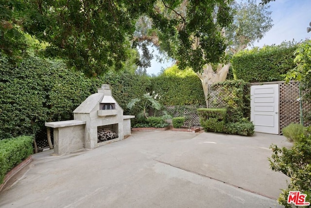 view of patio / terrace featuring an outdoor fireplace