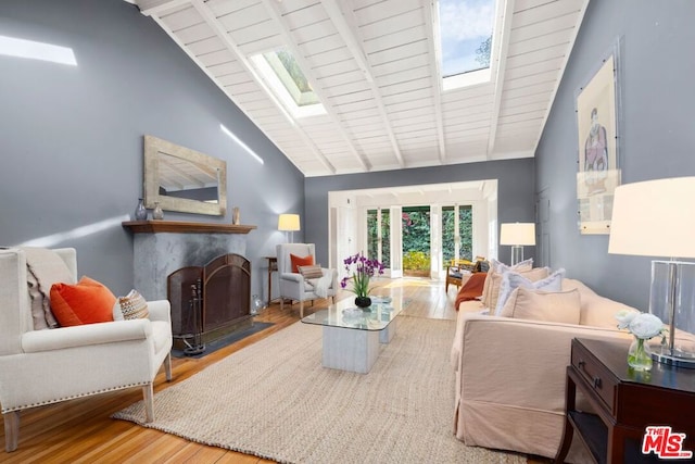 living room with beam ceiling, hardwood / wood-style floors, and high vaulted ceiling