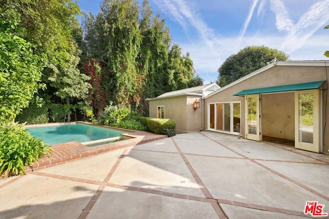 view of swimming pool featuring a patio area