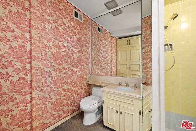 bathroom with a shower, vanity, and toilet