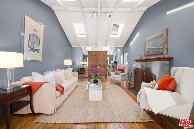 living room with hardwood / wood-style floors and lofted ceiling