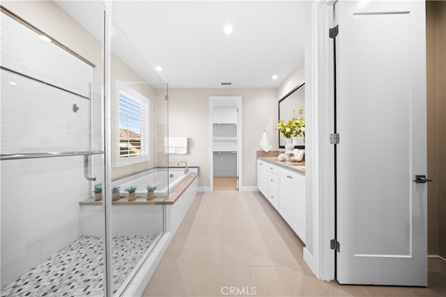 bathroom featuring vanity, tile patterned flooring, and independent shower and bath