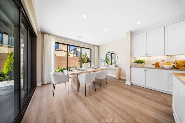 dining area with light hardwood / wood-style floors